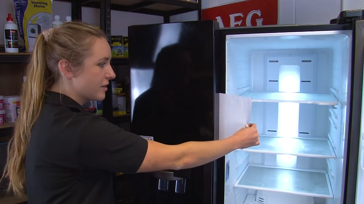 Checking The Freezer Door Seal By Placing A Sheet Of Paper Between The Freezer Door And Door Frame