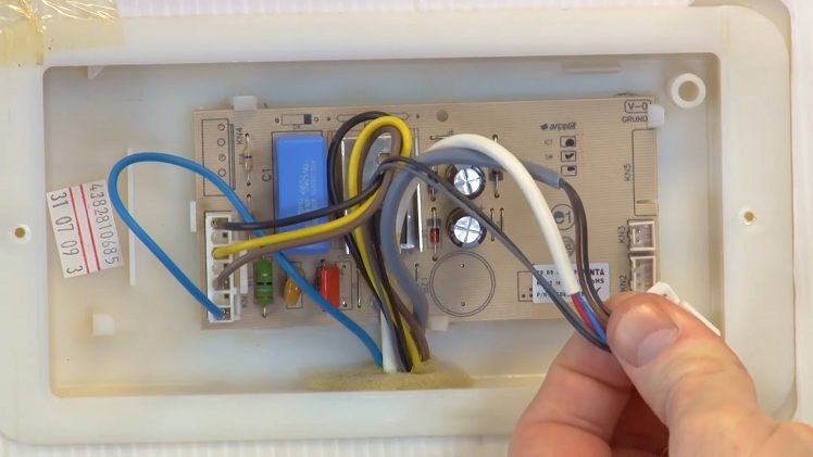 Squeezing And Pulling Out The Electrical Connections On Either Side Of The PCB