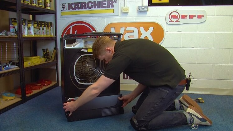 Holding And Pulling Away The Tumble Dryer Lower Panel