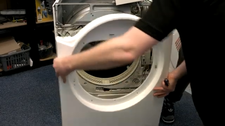 Lifting Up The Front Panel Of The Tumble Dryer And Putting It To One Side
