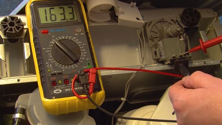 Place the two multimeter probes onto the drain pump's tabs from which you removed the electrical connections