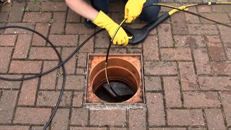 Feeding The Karcher Drain Cleaning Kit Into A Drain