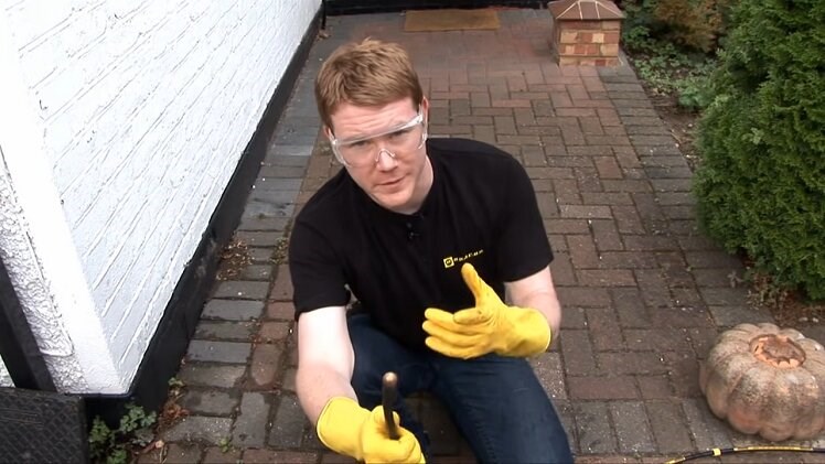 Wearing Safety Goggles And Gloves To Avoid Any Splashback Before Clearing A Blockage