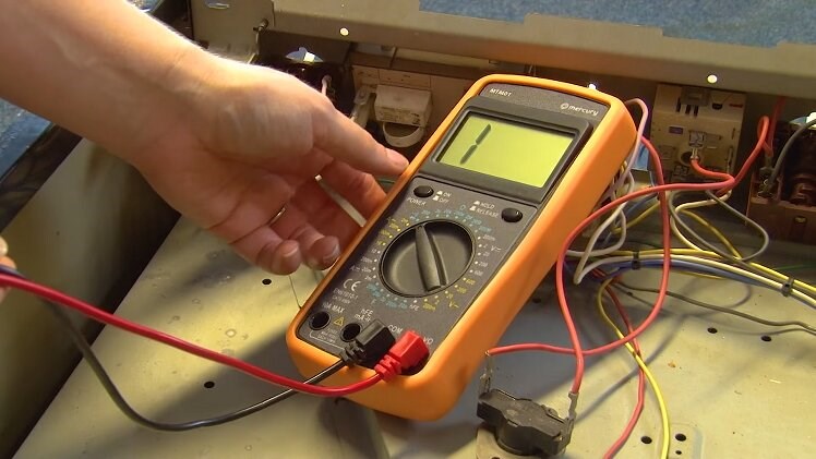 The multimeter on the continuity setting with the black and red probe connected