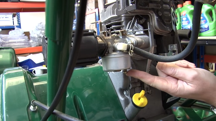 Draining The Fuel From The Petrol Lawnmower Carburettor By The Little Release Valve