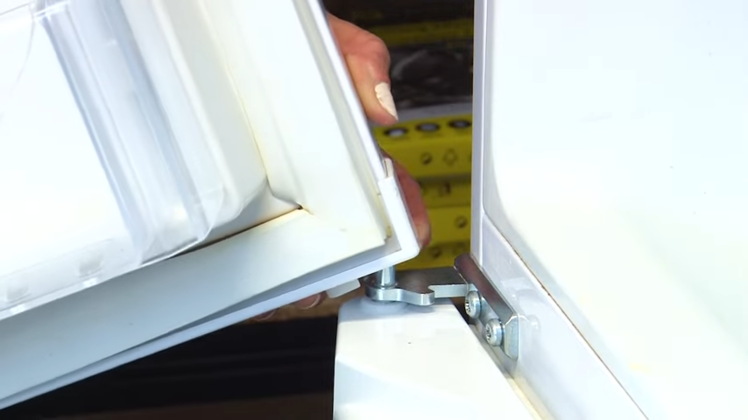 Reattaching The Fridge Door By Slotting It Onto The Central Hinge