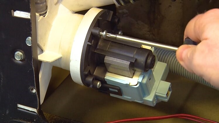 Use a T15 Torx screwdriver to unscrew the three screws that hold the drain pump in place