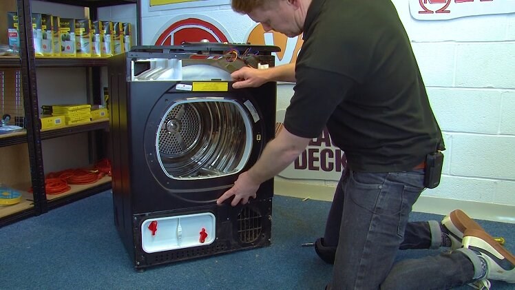 Putting The Front Panel On The Front Of The Tumble Dryer