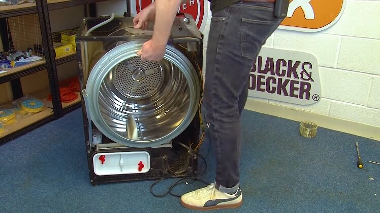 Slotting The Drum Back Into Place Inside The Tumble Dryer