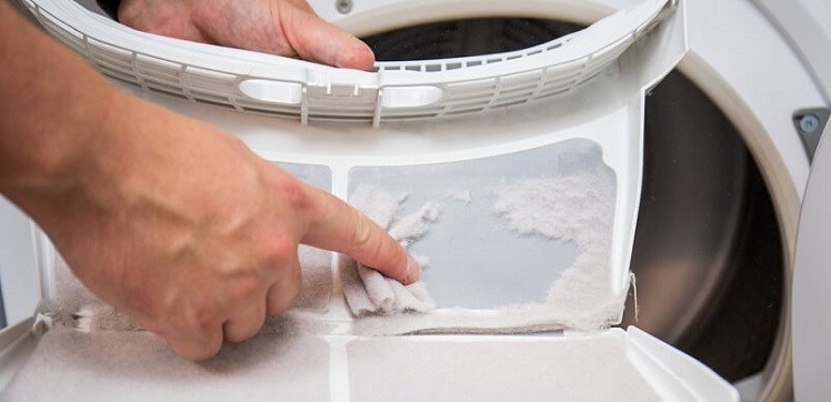 Hand Wiping Lint Off Tumble Dryer Filter