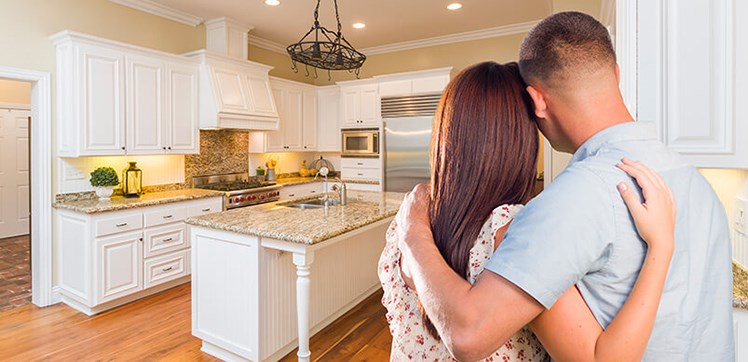 Couple standing back and admiring their home