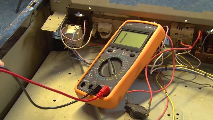 The multimeter set on the continuity setting with the black and red probes connected