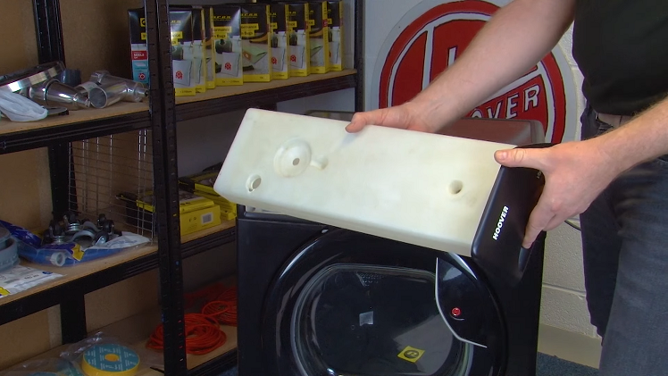 Pull out the water tray from the top of the tumble dryer, using both hands to hold it steady to avoid any spillages