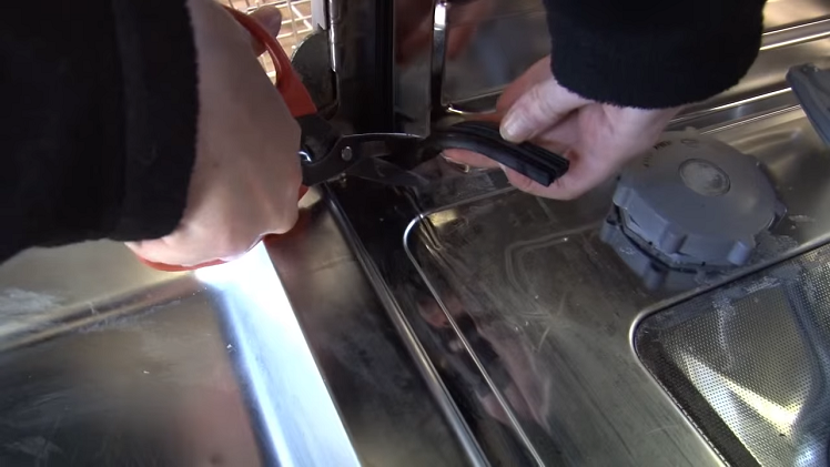 Cutting Off Any Excess Door Seal With A Pair Of Scissors