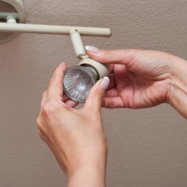 Woman changing LED bulb