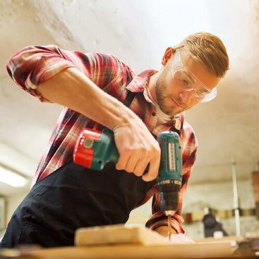 Man drilling through wood