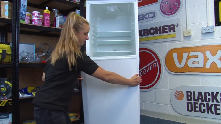 Gently Lifting The Freezer Door Off The Bottom Hinge