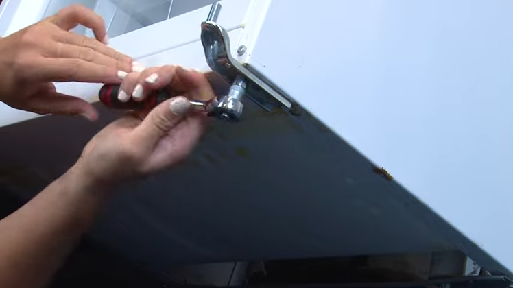 Removing The Two Head Bolts Underneath The Appliance With A Ratchet