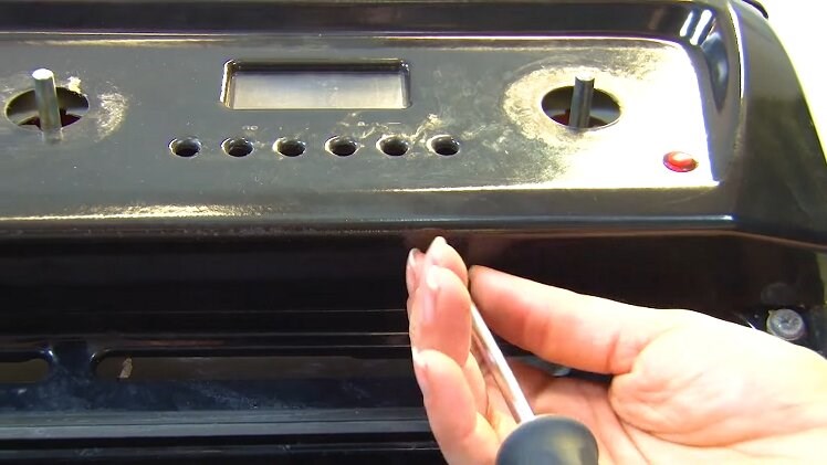 Use a Phillips screwdriver to remove the other screw on the underside of the control panel