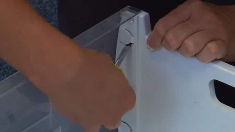 Using A Flat Blade Screwdriver To Break All Four Tabs On The Inside Of The Freezer Drawer