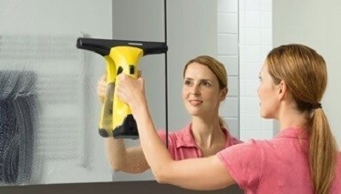 Woman cleaning oven with window vacuum