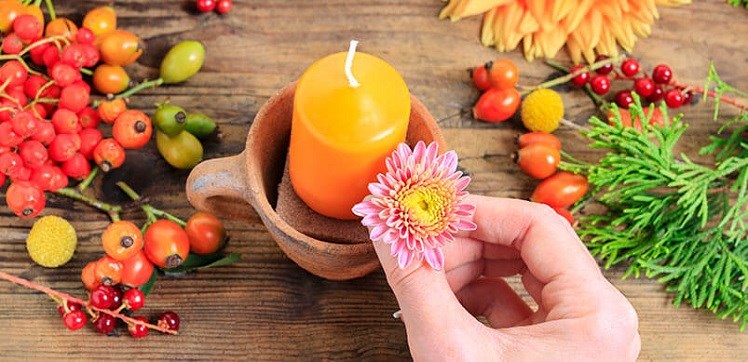 Female Hand Placing Flower In DIY Candle Pot