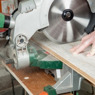 Electric saw secured to workbench