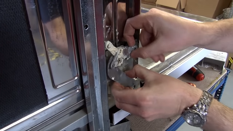 Pulling The Hinge Lever Free From The Dishwasher