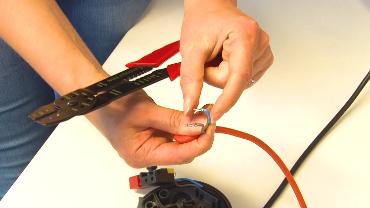 Using A Wire Stripper To Strip The Cable To Expose The Wires