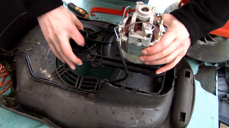 Lifting The Motor And Drive Assembly Out Of The Lawnmower By Hand