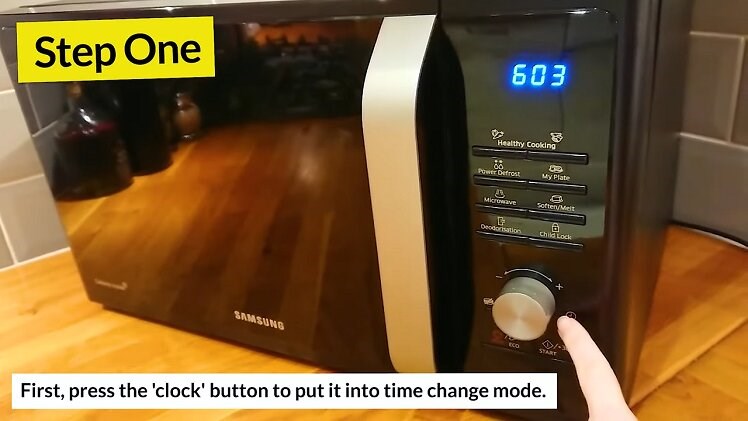 Pressing The Button Beneath The Clock Icon On The Front Of The Samsung Microwave To Enter Time Change Mode
