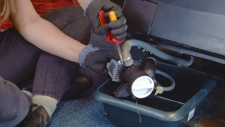 To fit the new pump, reattach the sump hose and drain hose to the new pump using your pliers to secure the metal clips.