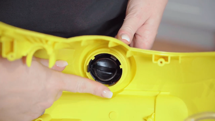 To remove the Karcher control knob from the casing, squeeze in the three small black clips that keep the knob held into place.