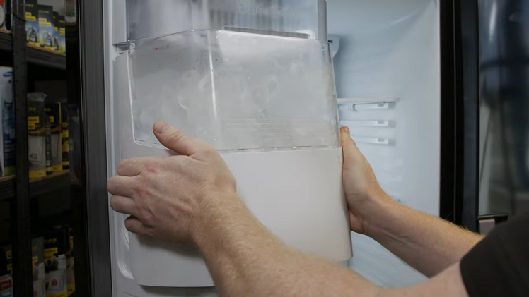 Pulling The Two Locking Clips On Either Side Of The Ice Bucket Then Sliding The Bucket Out Slowly With Both Hands