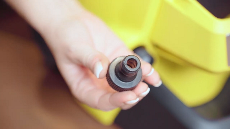 Unscrew and remove the small black water inlet hose connection.
