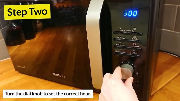 Turning The Large Circular Dial On The Samsung Microwave Until It Reaches The Correct Hour