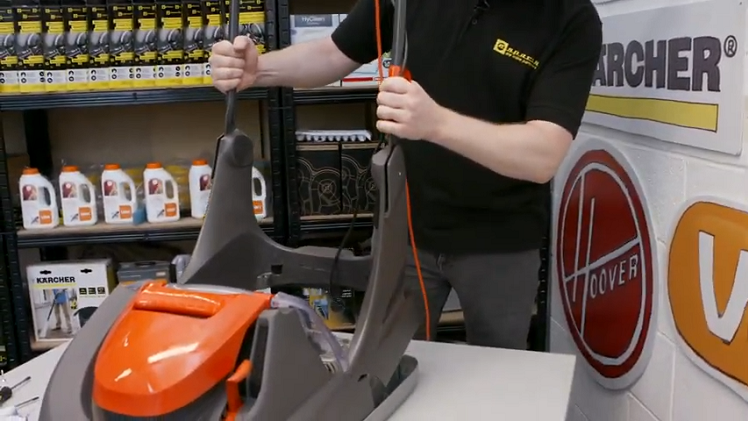 Placing The Handle Back Into Place Over The Lawnmower