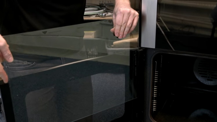 Carefully Slotting The Door Glass Into Place So It Reaches The Plastic Stops At The Bottom