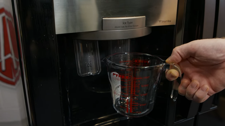 Checking The Water Pressure Of The Dispenser By Holding A Measuring Cup Beneath The Dispenser And Allowing It To Fill Up For Ten Seconds