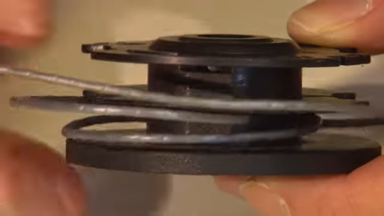 Removing Any Excess Line By Gently Unwinding It And Pulling It Away From The Spool