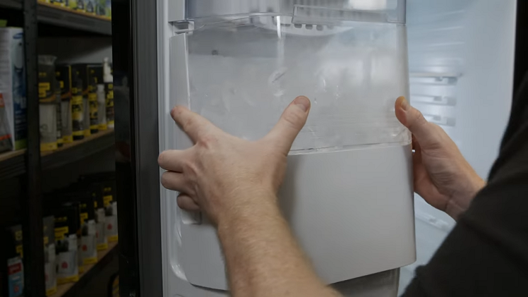 Reattaching The Ice Bucket By Slotting It Into Place Inside The Freezer