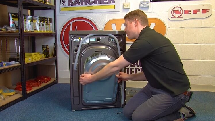 Pull the back panel away from the washing machine by hand and place it aside along with the screws
