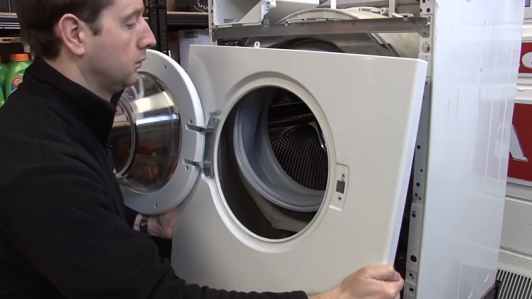 Fully remove the front panel by working it away from the washing machine and placing it aside.
