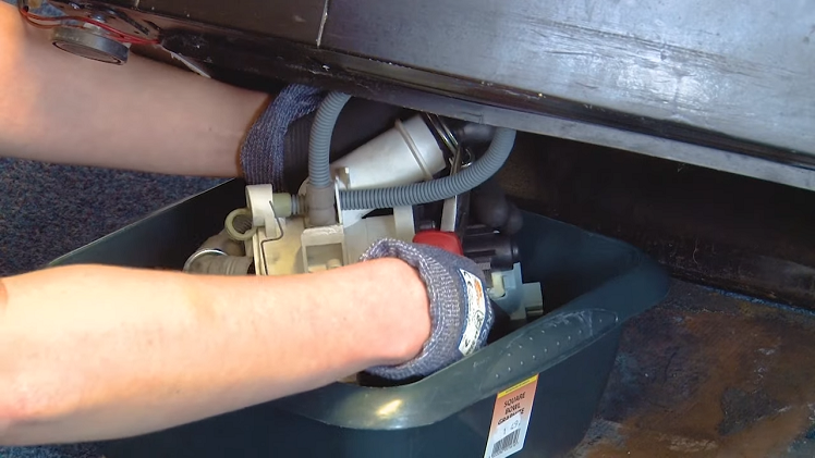 Use your pliers to open the metal clip that holds the sump hose onto the drain pump to release it.