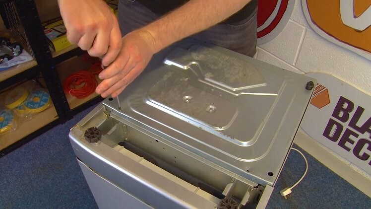 Refit the four screws to secure the bottom panel onto the bottom of the dishwasher