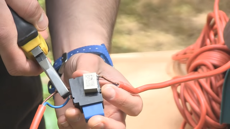 Using A Pair Of Pliers To Gently But Firmly Pull The Wires Out Of The Switch