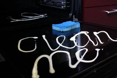 A Cleaning Cream And Sponge On A Ceramic Glass Hob Top