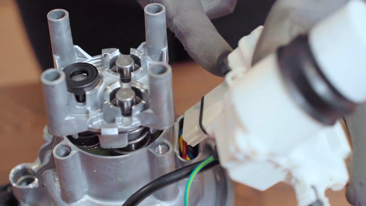Slot the plug into the side of the motor, making sure you hold the small black gasket in place so it doesn't fall off.