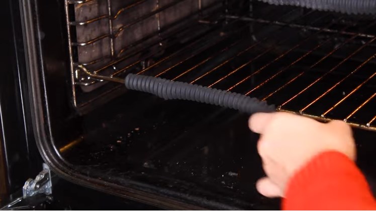 Slotting The Front Of The Oven Shelf Inside The Oven Shelf Guard