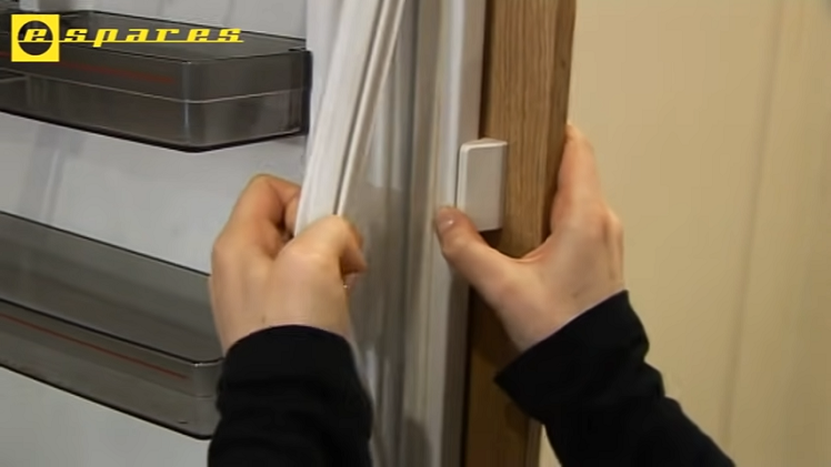 Pulling The Door Seal Away From The Fridge Door By Hand To Remove It